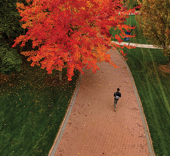 A woman sitting on a stool next to a podium